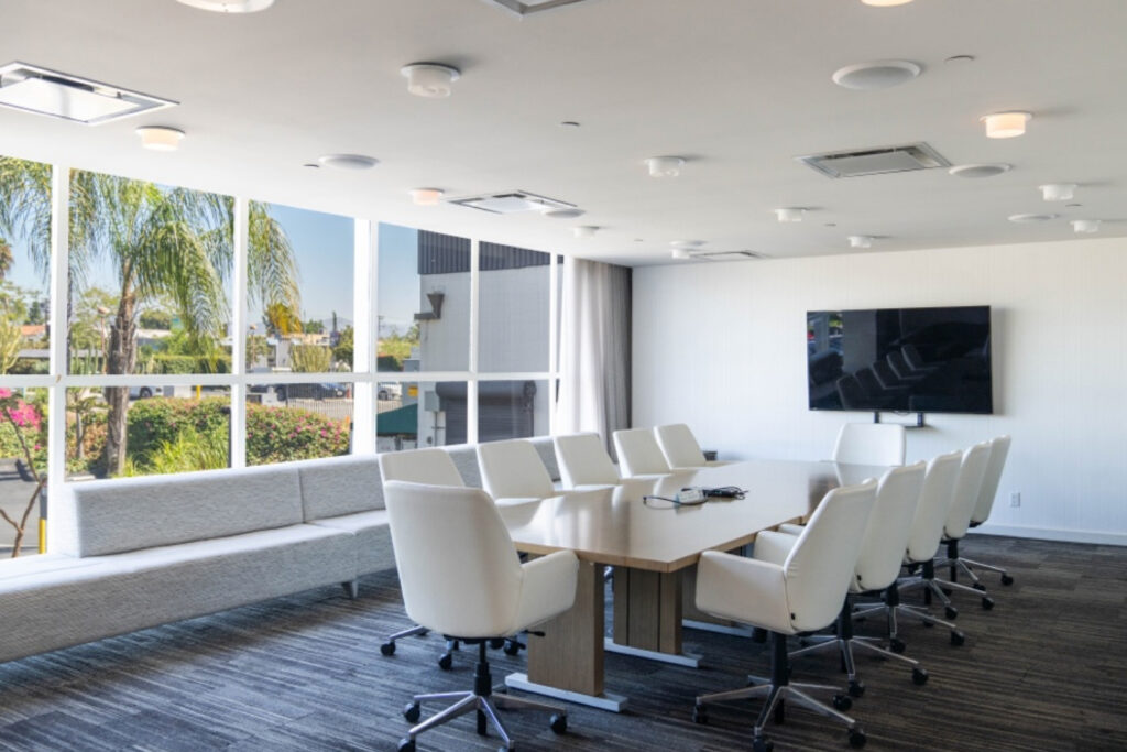 TVC Studios - Television City - Production Office Space - Conference Room Table with Tv and White Chairs